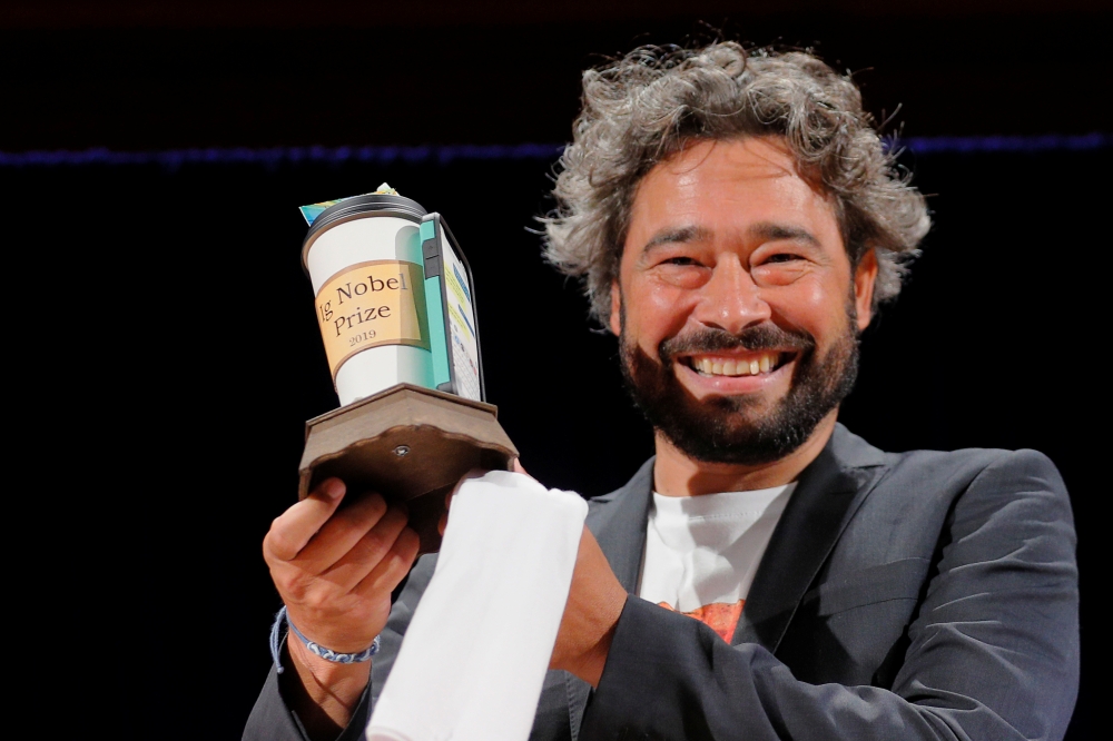 Silvano Gallus of Italy accepts the Ig Nobel Prize in Medicine for the study 