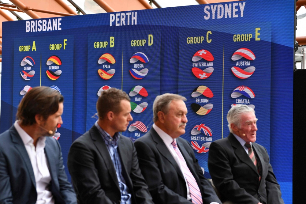 A screen showing the ATP Cup draw results (background) are seen as Australia's former tennis players (L-R), Pat Rafter, Lleyton Hewitt, John Newcombe and Ken Rosewall attend the event in Sydney on September 16, 2019. AFP / Saeed Khan 