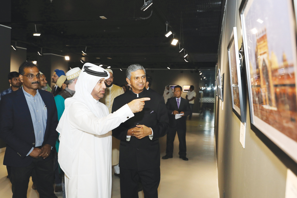 Dr. Khalid Bin Ibrahim Al Sulaiti, General Manager of Katara, and P Kumaran, Ambassador of India to Qatar, view the photos on display at the opening of “Islamic Monuments of India” on Tuesday at Katara Building No. 19.
