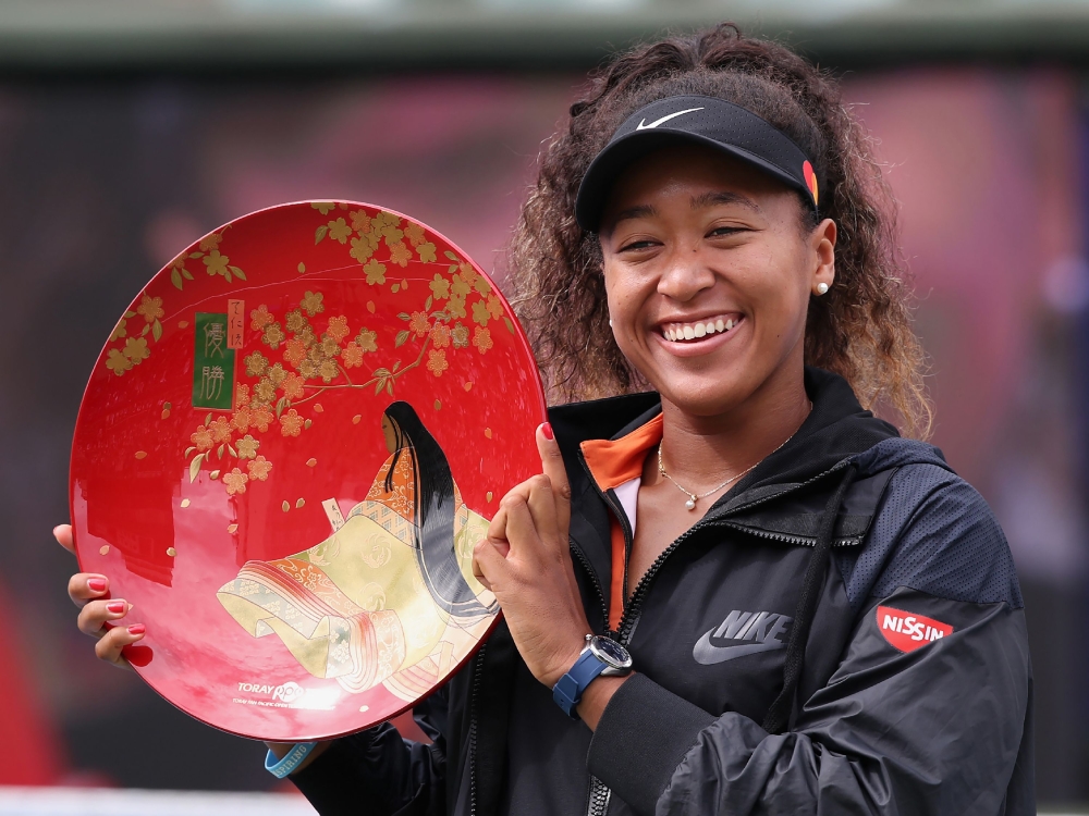 Pan Pacific Open women's singles winner Naomi Osaka holds a victory plate during the awarding ceremony in Osaka on September 22, 2019. - Japan OUT / AFP / JIJI PRESS / Jiji Press