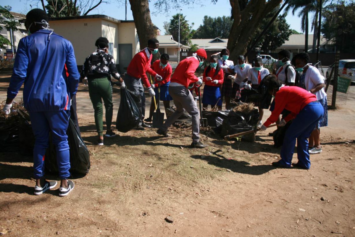 Students clean the streets of Harare Zimbabwe, September 5, 2019. Thomson Reuters Foundation/Tonderayi Mukeredzi