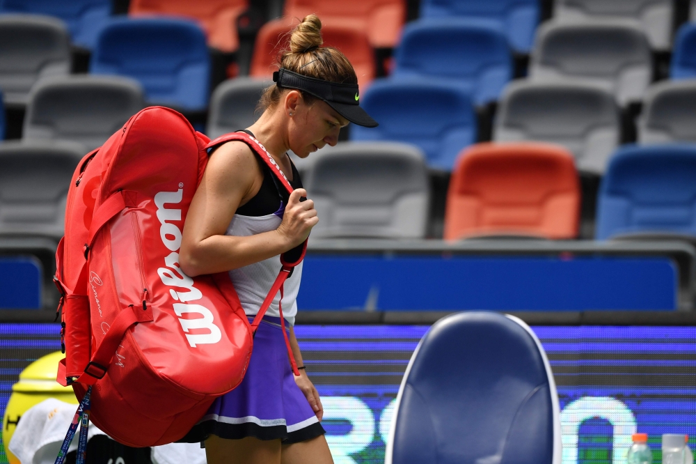 Simona Halep of Romania leaves the court following her third round women's singles match against Elena Rybakina of Kazakhstan at the Wuhan Open tennis tournament in Wuhan on September 25, 2019. / AFP / HECTOR RETAMAL