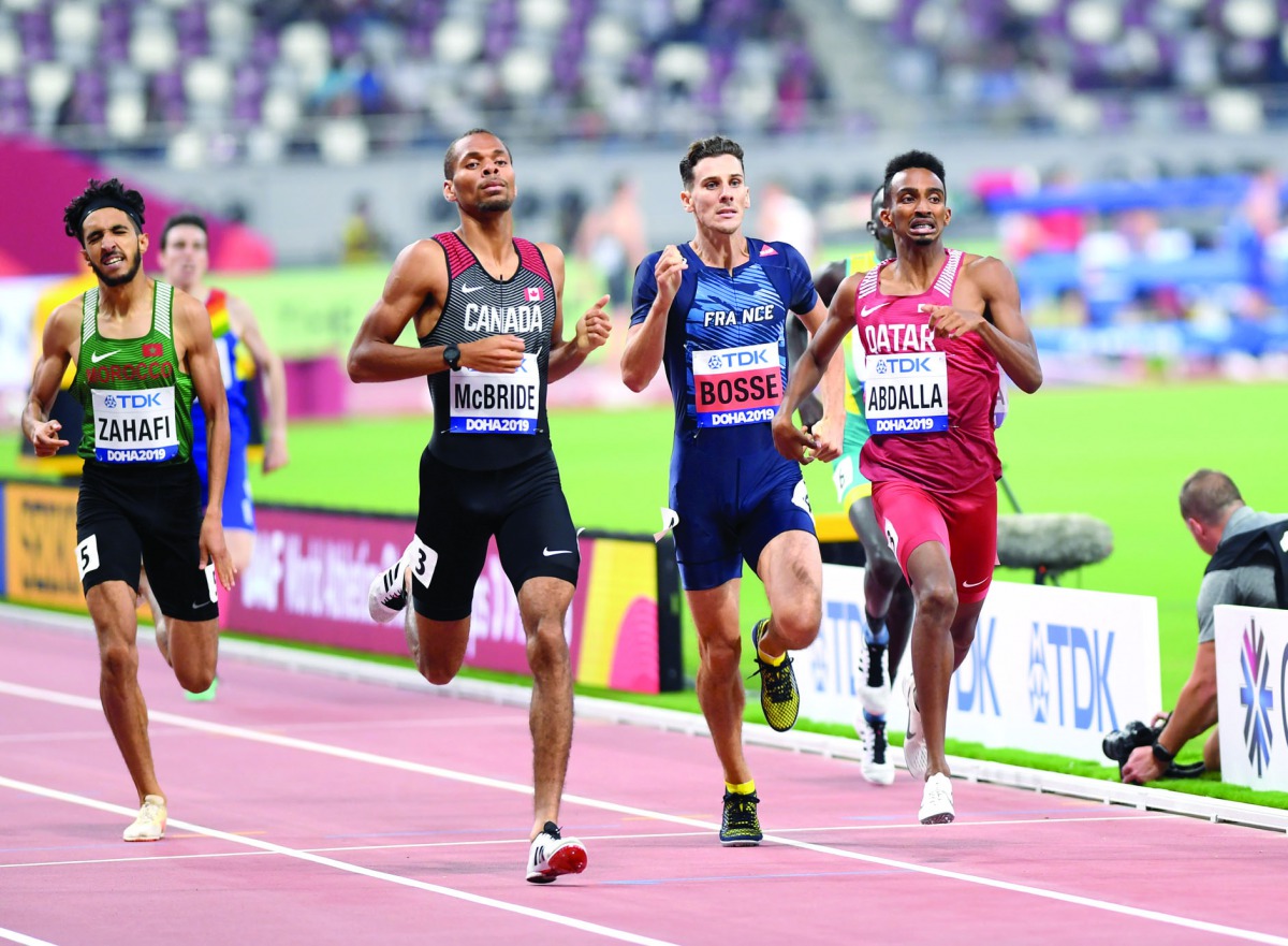 Qatar’s Abubaker Haydar Abdalla (right) crossing the finish line during the Men’s 800m heats yesterday. Picture: Abdul Basit / the Peninsula