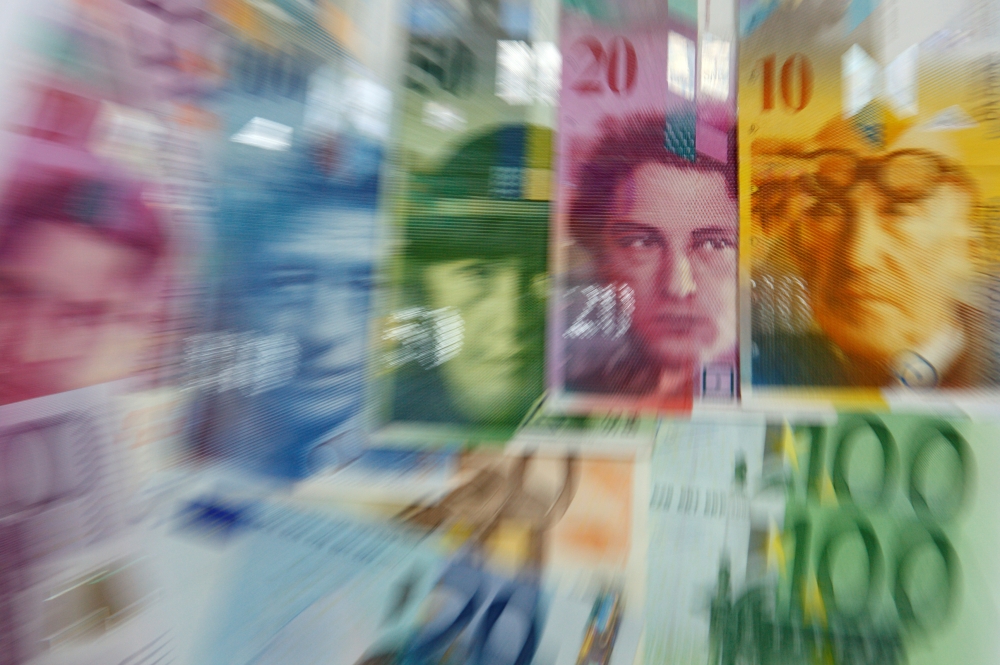 Various Euro banknotes lay next to various Swiss Franc notes in this picture illustration at a bank in Warsaw, July 18, 2011. Reuters/Kacper Pempel