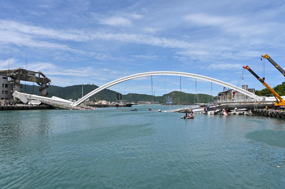 This general view shows a bridge after it collapsed in the Nanfangao fish harbour in Suao township on October 1, 2019. AFP / Sam YEH