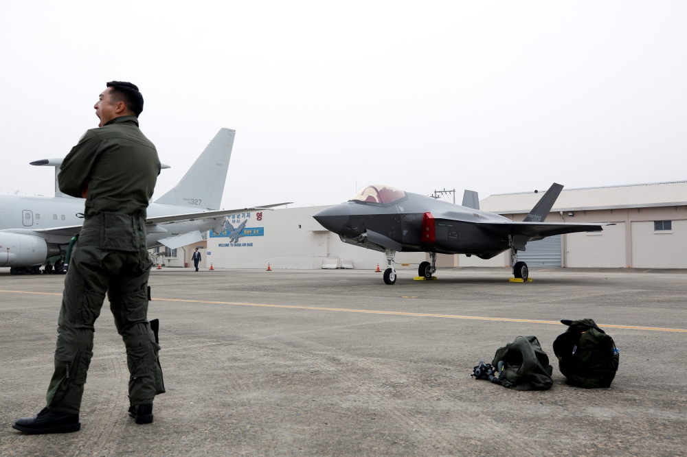 A South Korean fighter pilot stands next to his F-35 stealth fighter during a ceremony to mark the 71st Armed Forces Day at the Air Force Base in Daegu, South Korea, October 1, 2019. Jeon Heon-kyun/Pool via REUTERS