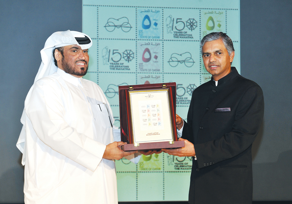 Chief Operations Officer, Qatar Post, Hamad Mohammed Al Fahida (left) presenting  commemorative stamps of Mahatma Gandhi, to the Ambassador of India to Qatar, P Kumaran, during the ’Celebrating  Khadi’ function organised by the Indian Embassy at VCUarts Q