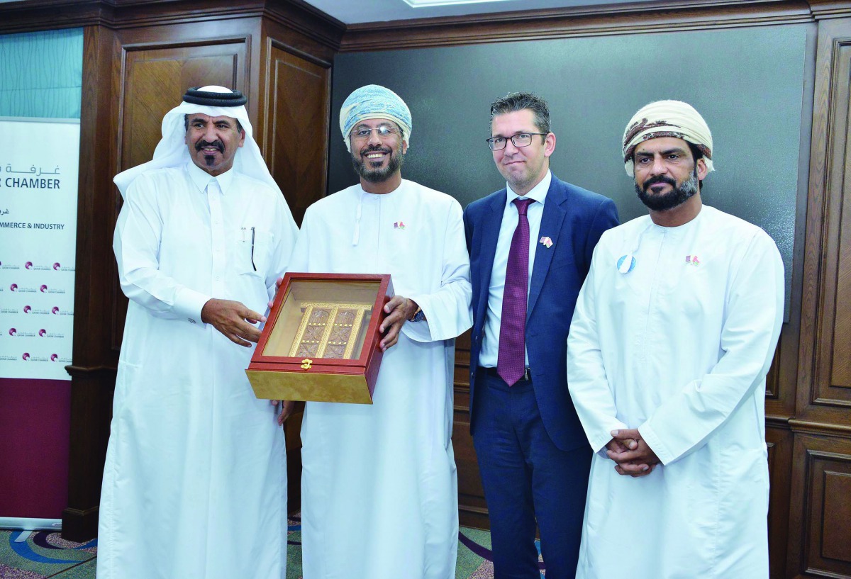 Qatar Chamber First Vice-Chairman, Mohamed bin Ahmed bin Towar Al Kuwari (left), presenting a memento to the visiting Omani officials.