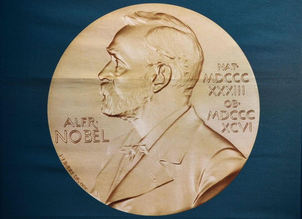A portrait of Alfred Nobel can be seen on a banner on display at the Nobel Forum in Stockholm , Sweden on October 01, 2018. AFP / Jonathan Nackstrand
 