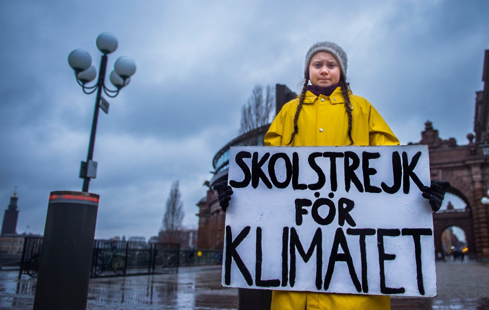 Greta Thunberg holds a placard reading School strike for the climate outside the Swedish parliament in Stockholm, Nov 30, 2018. TT News Agency / Hanna Franzen / Reuters