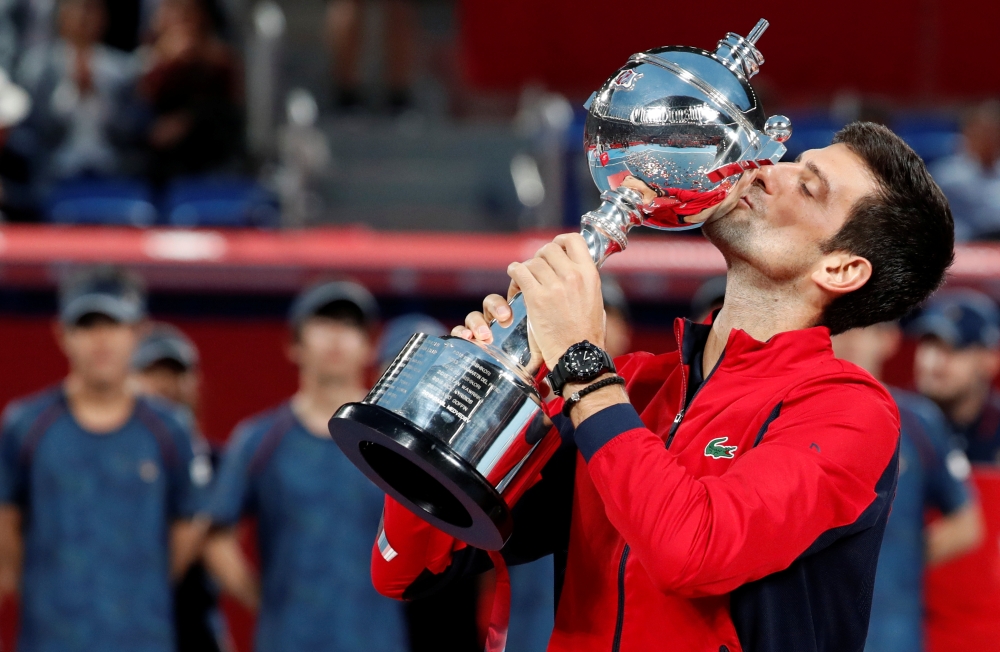 Novak Djokovic of Serbia kisses the trophy after winning. REUTERS/Kim Kyung-Hoon