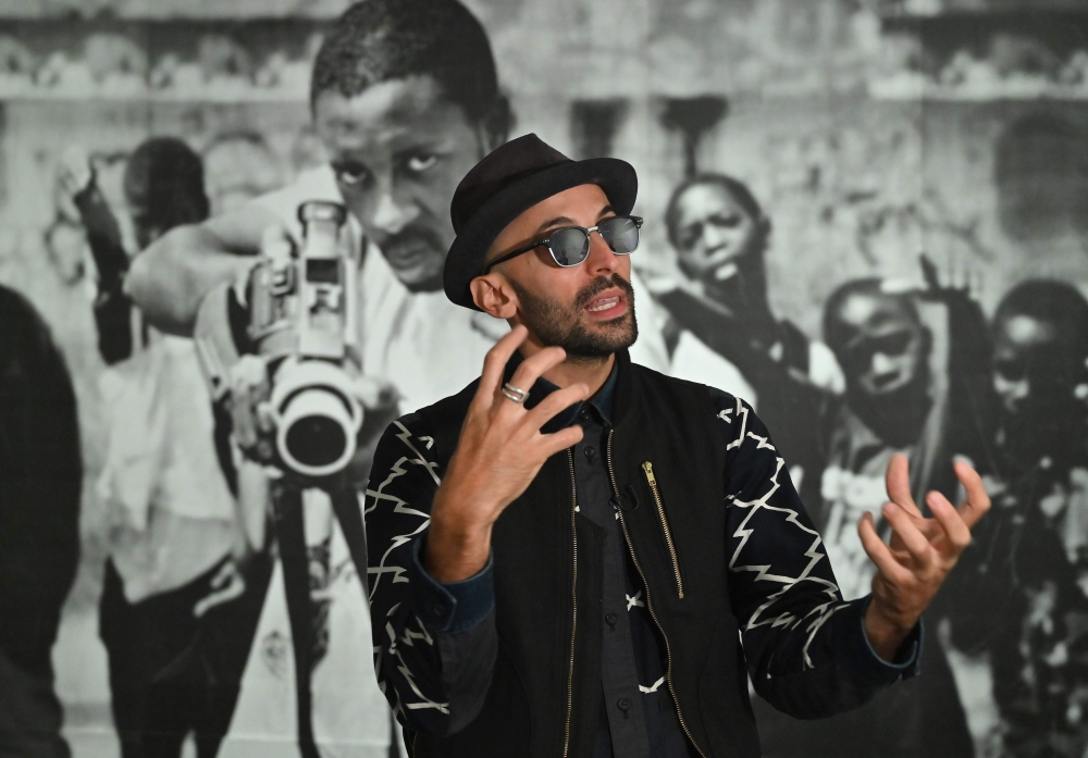 French-born artist JR speaks during an interview prior to the opening of his exhibition 