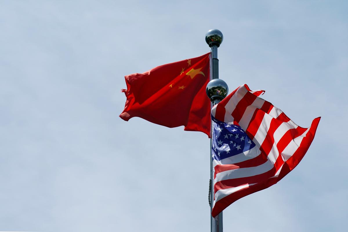 FILE PHOTO: Chinese and US flags flutter near The Bund, before US trade delegation meet their Chinese counterparts for talks in Shanghai, China July 30, 2019. REUTERS/Aly Song
