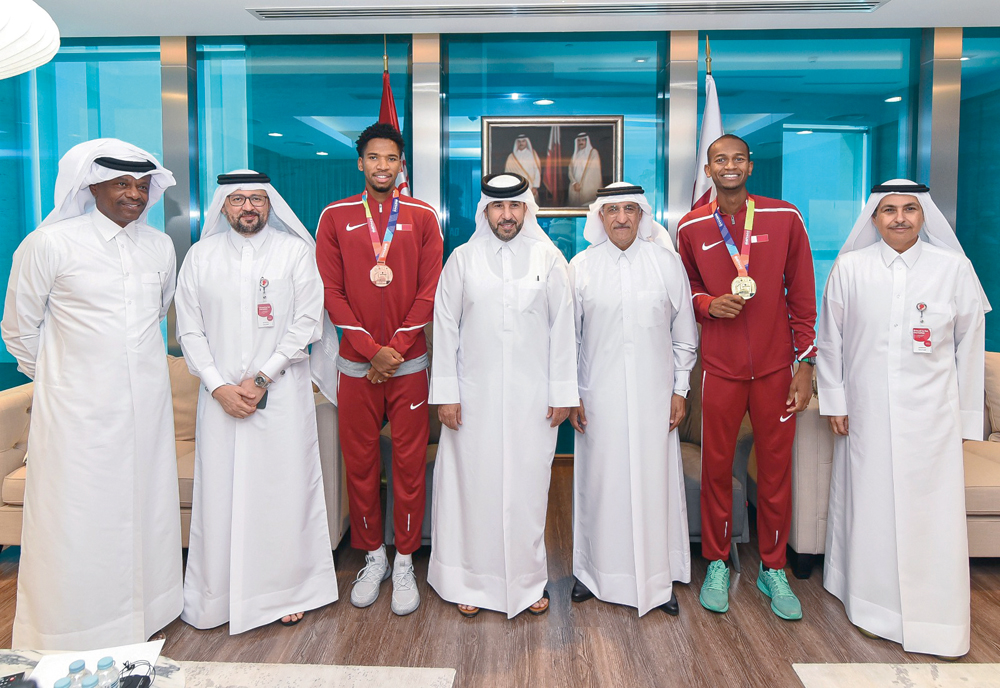 Officials of Ooredoo with Qatari athletes Mutaz Essa Barshim and Abderrahman Samba.