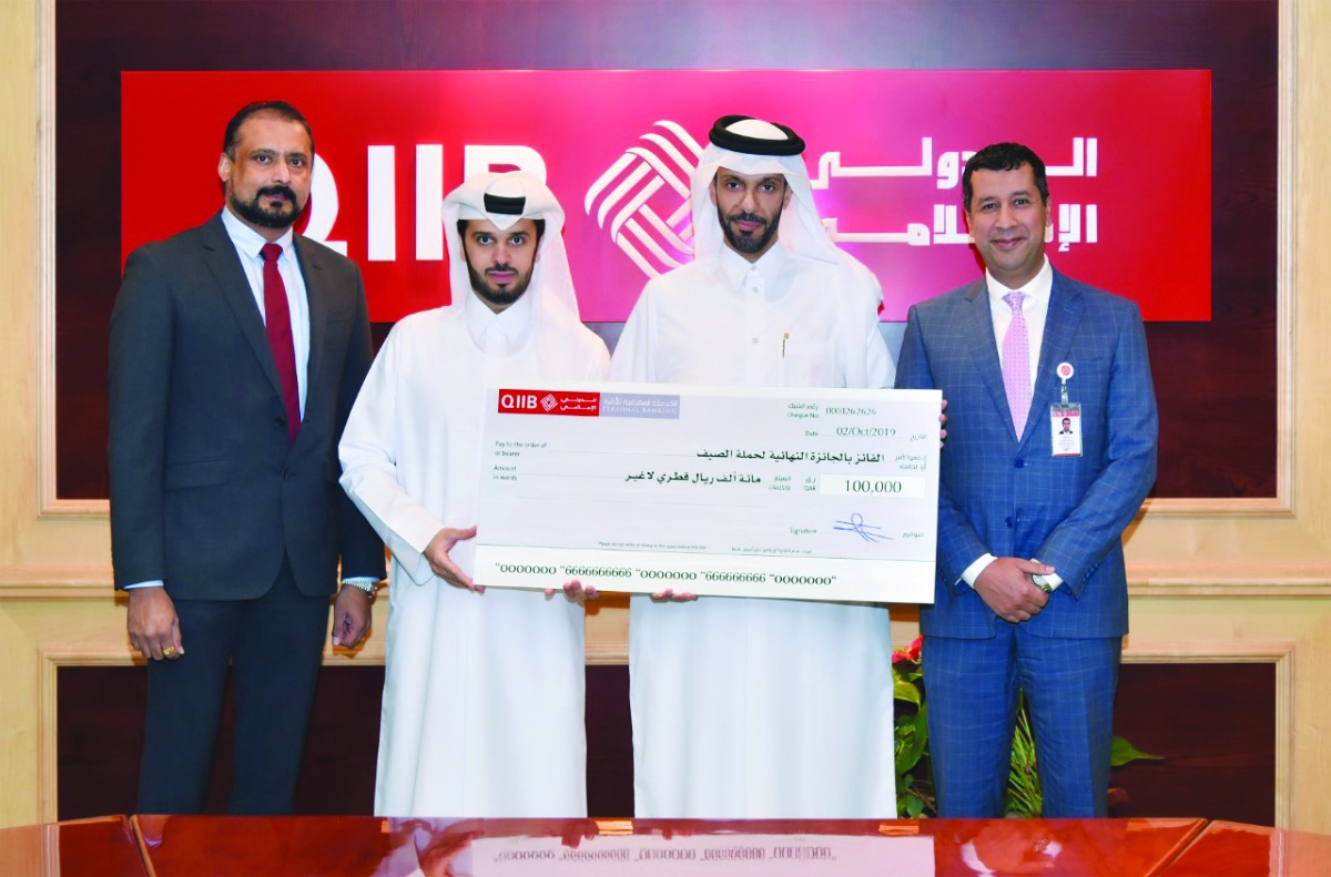 Omar Abdulaziz Al Meer (second left), QIIB Chief (Business Development); Zakaria Glaoui (right), Chief (Retail Banking) at QIIB; and Dr. Sudheer Nair (left), Country Manager –Visa Qatar with the final prize winner Abdulla Ojan Alkhayareen.