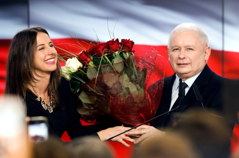 Poland's ruling party Law and Justice (PiS) leader Jaroslaw Kaczynski receives flowers after the exit poll results are announced in Warsaw, Poland, October 13, 2019. REUTERS/Kacper Pempel