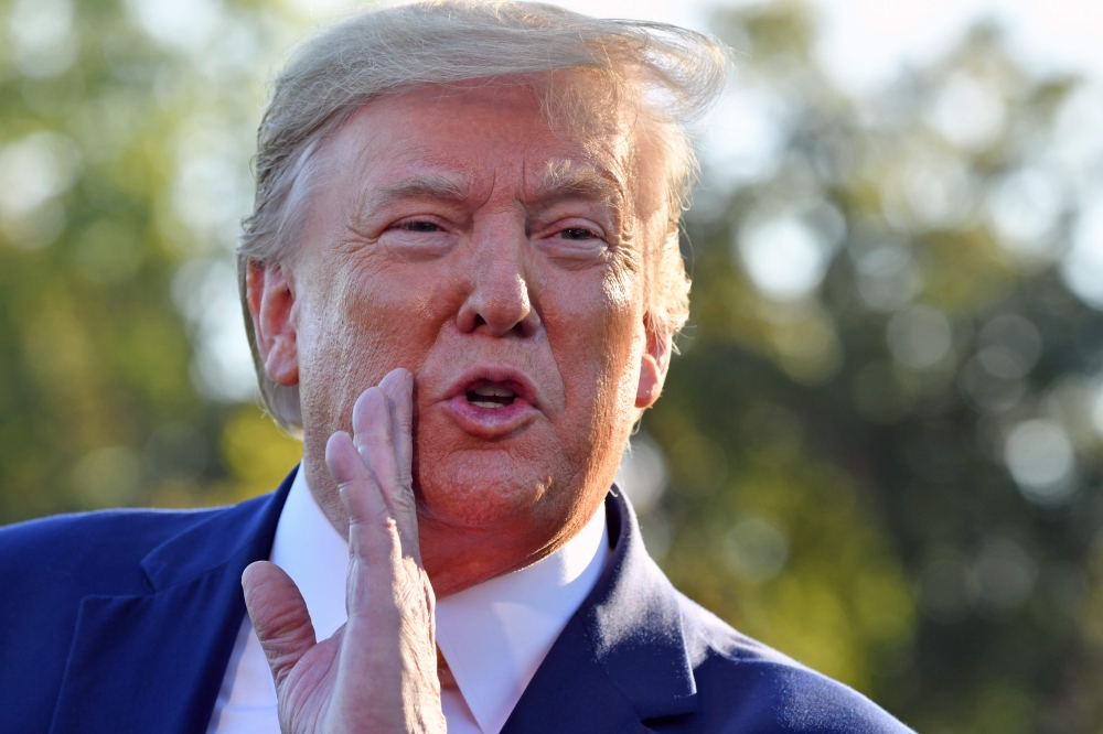 US President Donald Trump speaks to the press after announcing and initial deal with China at the South Lawn of the White House in Washington, DC before departing to Lake Charles, Louisiana to hold a campaign rally on October 11, 2019.  AFP / Nicholas Kam