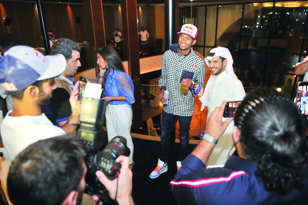Qatar’s world champion in high jump Mutaz Essa Barshim interacts with fans during the Red Bull event in Doha.