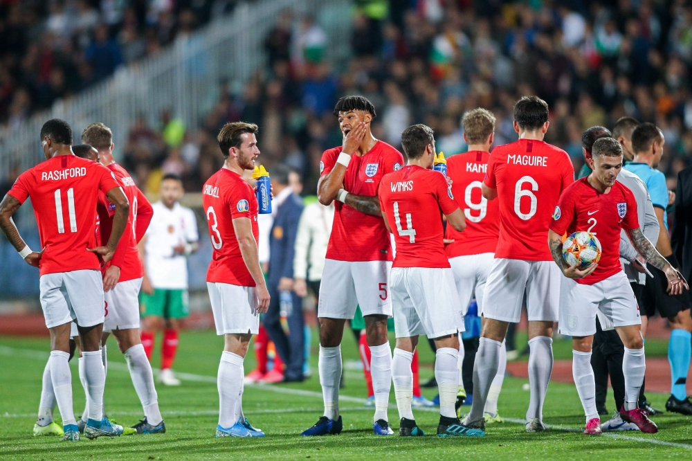 England's players wait on the pitch during temporary interruption of the Euro 2020 Group A football qualification match between Bulgaria and England due to incidents with fans, at the Vasil Levski National Stadium in Sofia on October 14, 2019. AFP / Strin