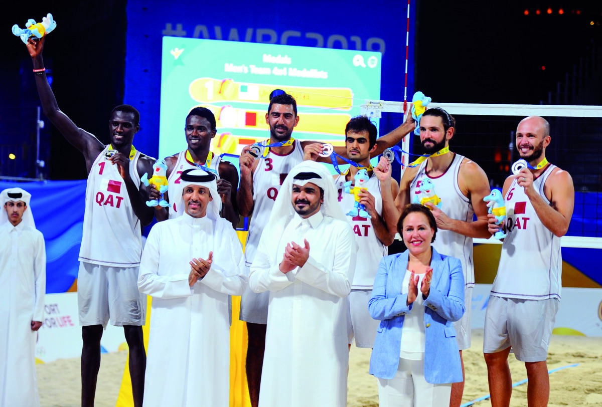 President of Qatar Olympic Committee, H E Sheikh Joaan bin Hamad Al Thani posing for a photograph with the Qatar 4x4 beach volleyball team after they won the silver medal on the final day of the ANOC World Beach Games at Katara beach, yesterday. Picture: 