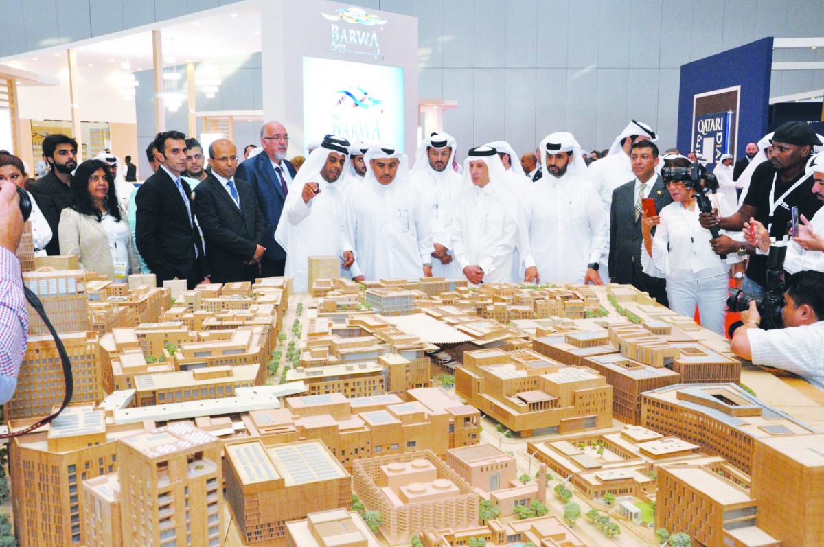 H E Ali bin Ahmed Al Kuwari, Minister of Commerce and Industry, and other dignitaries visiting the Msheireb Properties pavilion at the Cityscape Qatar 2019, yesterday.  