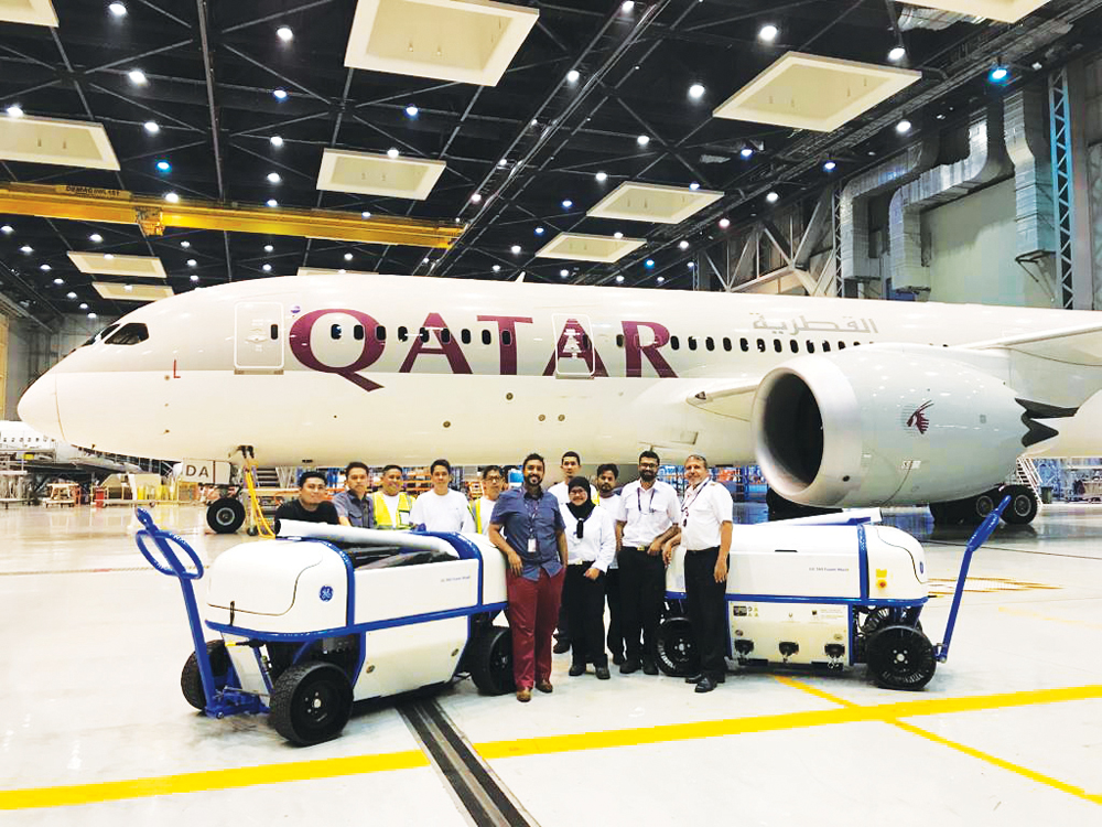 Qatar Airways staff pose for a group photo.