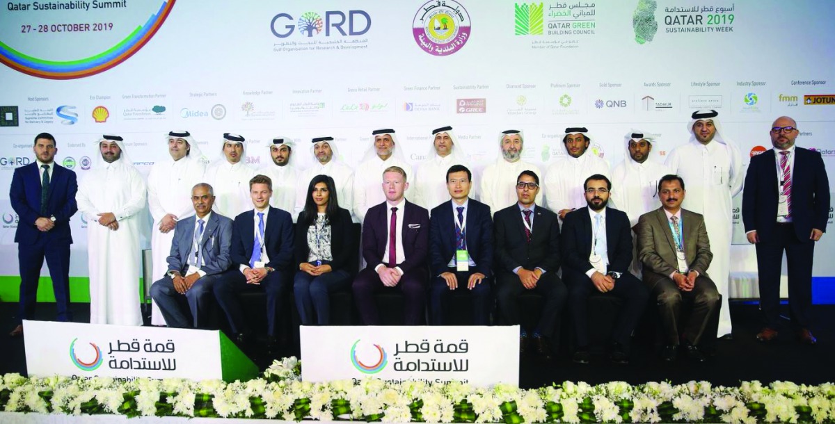 The organisers and delegates of the Qatar Sustainability Summit, posing for a photograph with  Qatar Football Association and Qatar Stars League officials.