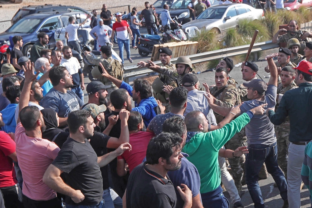Lebanese army soldiers clash with protesters as they attempt to reopen the main highway that links the cities of Saida and Beirut near the town of Jiyeh, south of the Lebanese capital Beirut, on October 30, 2019. AFP