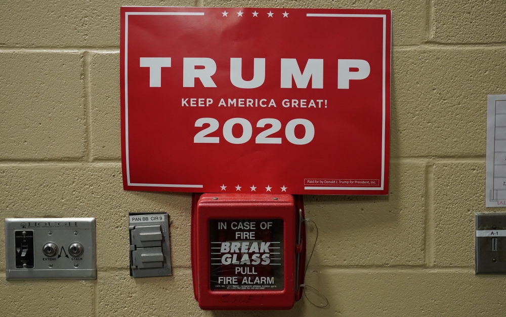 A Trump 2020 campaign poster is seen on a fire alarm during a campaign rally by Donald Trump in Fayetteville, North Carolina, US, September 9, 2019. Reuters / Kevin Lamarque
