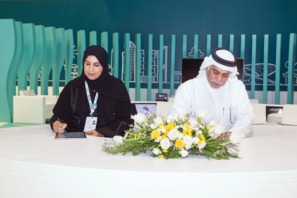 Yousuf Abdulla Al Kubaisi, Chief Operating Officer, Ooredoo Qatar,  and Maha Al Mansouri, CEO of MADA, signing the agreement. 