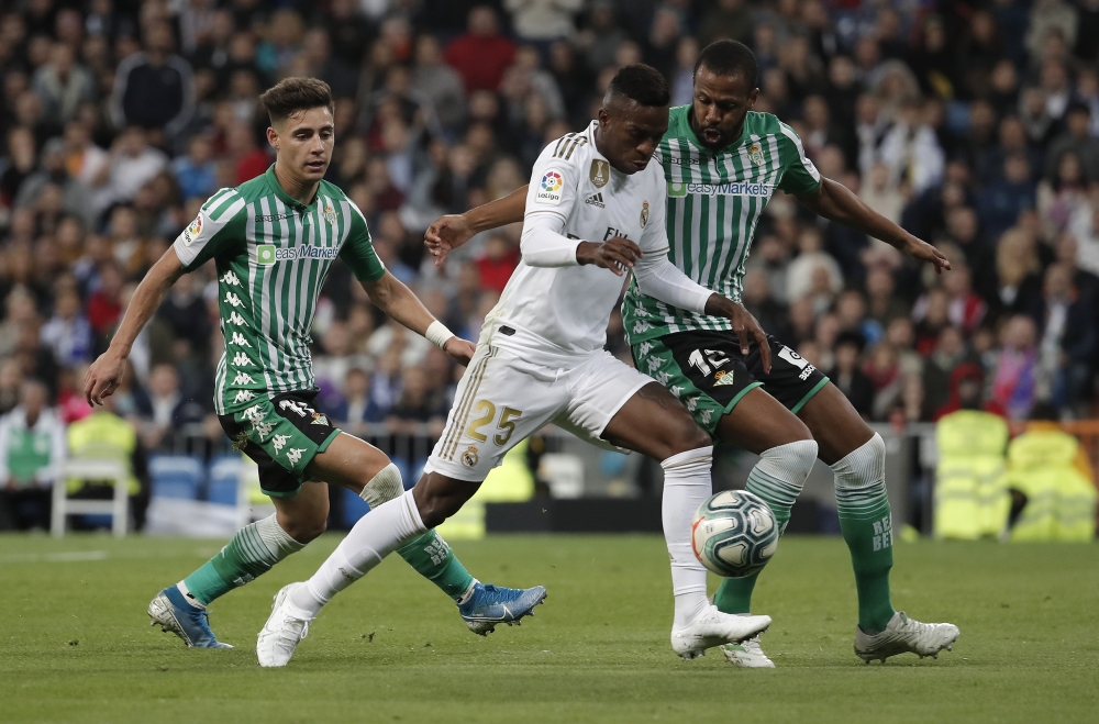 Vinicius Junior (C) of Real Madrid in action against Sidnei (R) of Real Betis Balompie during the La Liga match between Real Madrid CF and Real Betis Balompie at Santiago Bernabeu Stadium on November 02, 2019 in Madrid, Spain. Burak Akbulut - Anadolu 