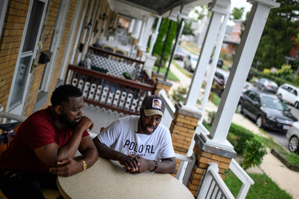 Baltimore resident and gunshot survivor Antonio Pinder (R), 31, speaks during an interview as his uncle Lamont Medley (L) listens West Baltimore on September 12, 2019. AFP / Eric Baradat