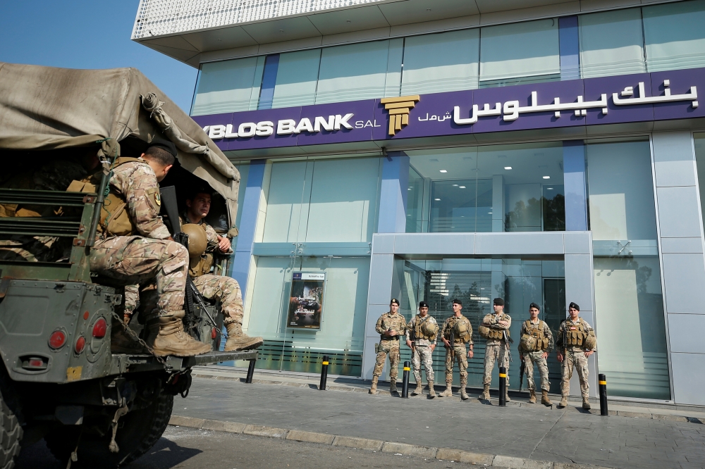 Lebanese army soldiers stand guard outside a branch of Byblos Bank in the southern city of Sidon, Lebanon November 4, 2019. REUTERS/Ali Hashisho