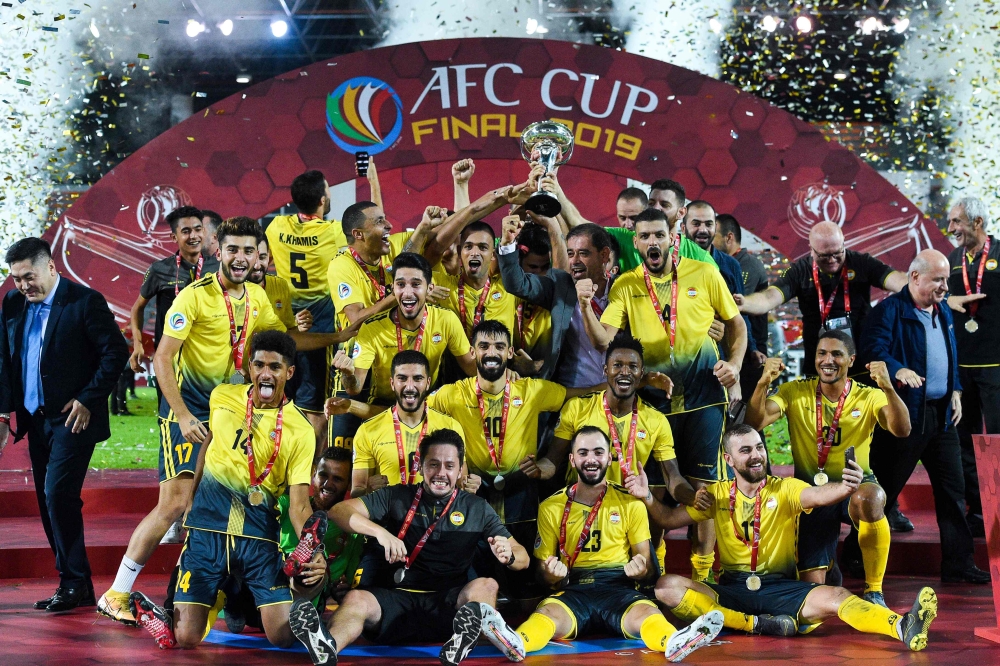 Al Ahed's players and coaching staff celebrate with the trophy after winning the 2019 AFC Cup Final between North Korea's April 25 Sports Club and Lebanon's Al Ahed FC at Kuala Lumpur Stadium in Kuala Lumpur on November 4, 2019. / AFP / Mohd RASFAN