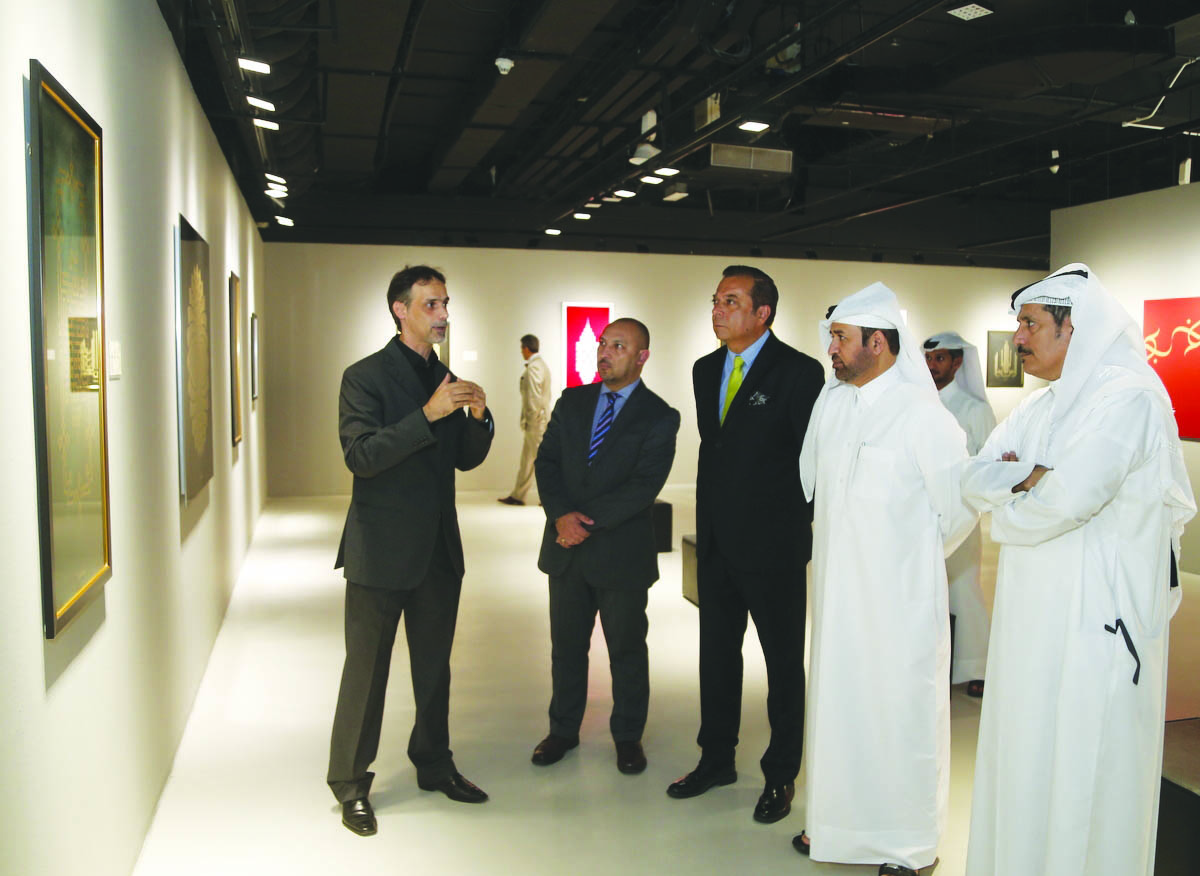 Dr. Khalid bin Ibrahim Al Sulaiti (second right), General Manager of Katara, and calligrapher and artist Ammar Al Desouki (left) along with other guests tour the “Preserved Pearls” exhibition during its opening on Monday.