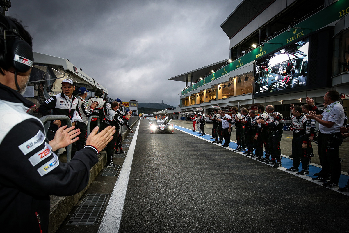 GAZOO Racing team members applaud as the No. 8 TS050 Hybrid Electric  Vehicle  arrives  at  the  pit after winning the 6 Hours of Fuji Race at the Fuji Speedway. 
