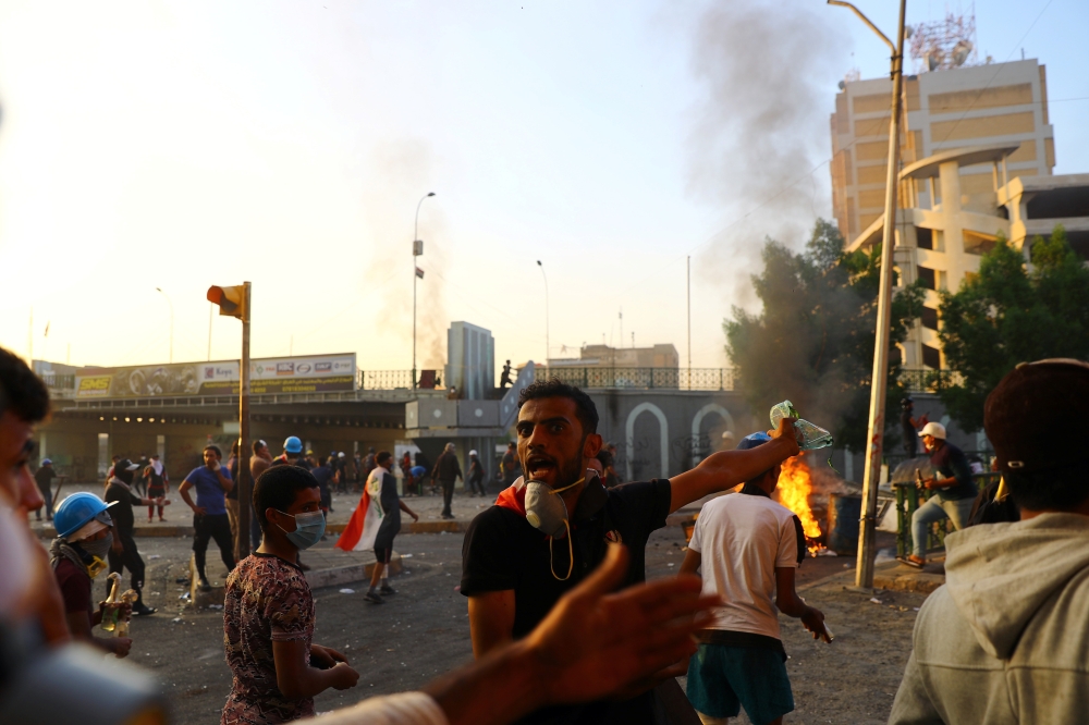 An Iraqi demonstrator reacts as protesters clash with Iraqi security forces during the ongoing anti-government protests in Baghdad, Iraq November 9, 2019. REUTERS/Ahmed Jadallah