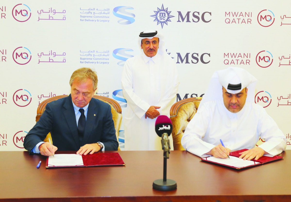 The Minister of Transport and Communications and Board Chairman of Qatar Ports Management Company (Mwani Qatar), H E Jassim bin Saif Al Sulaiti, witnessing the signing agreement by Mwani Qatar CEO Captain Abdullah Al Khanji (right) and Executive Chairman,