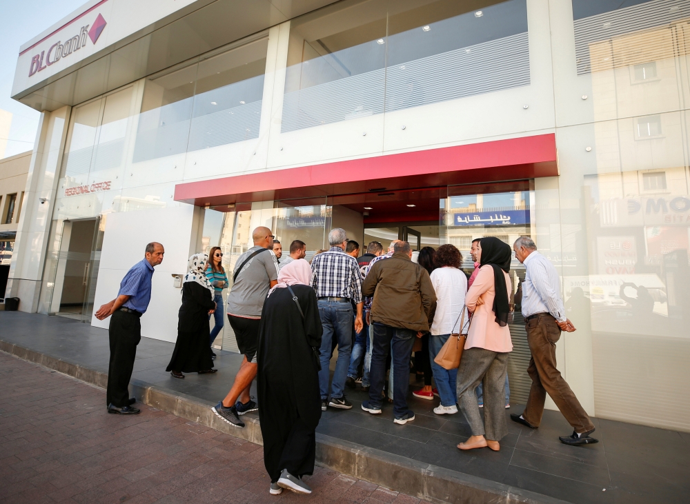 People queue outside a branch of BLC bank in Sidon, Lebanon November 19, 2019. REUTERS/Ali Hashisho