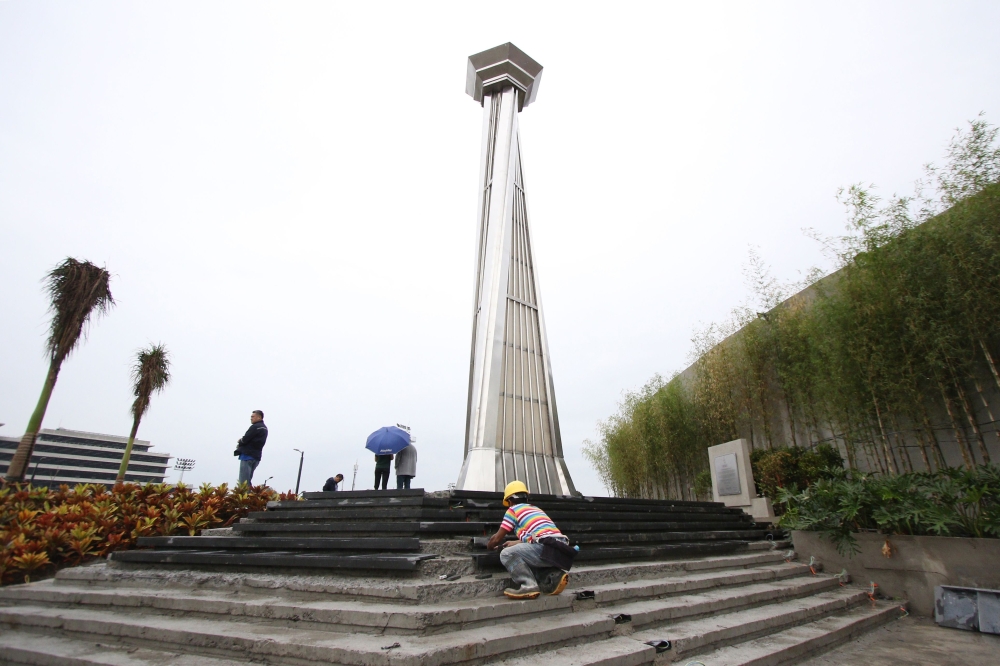This photo taken on November 21, 2019, shows workers preparing steps leading to the cauldron tower at the athletics stadium for the upcoming 2019 SEA Games at New Clark City in Tarlac, north of Manila. AFP / STR