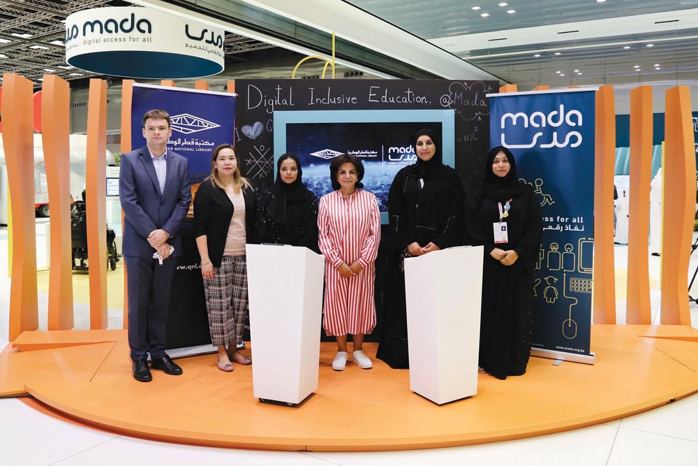 QNL and Mada officials after signing the agreement during the Qatar Information Technology Conference and Exhibition.