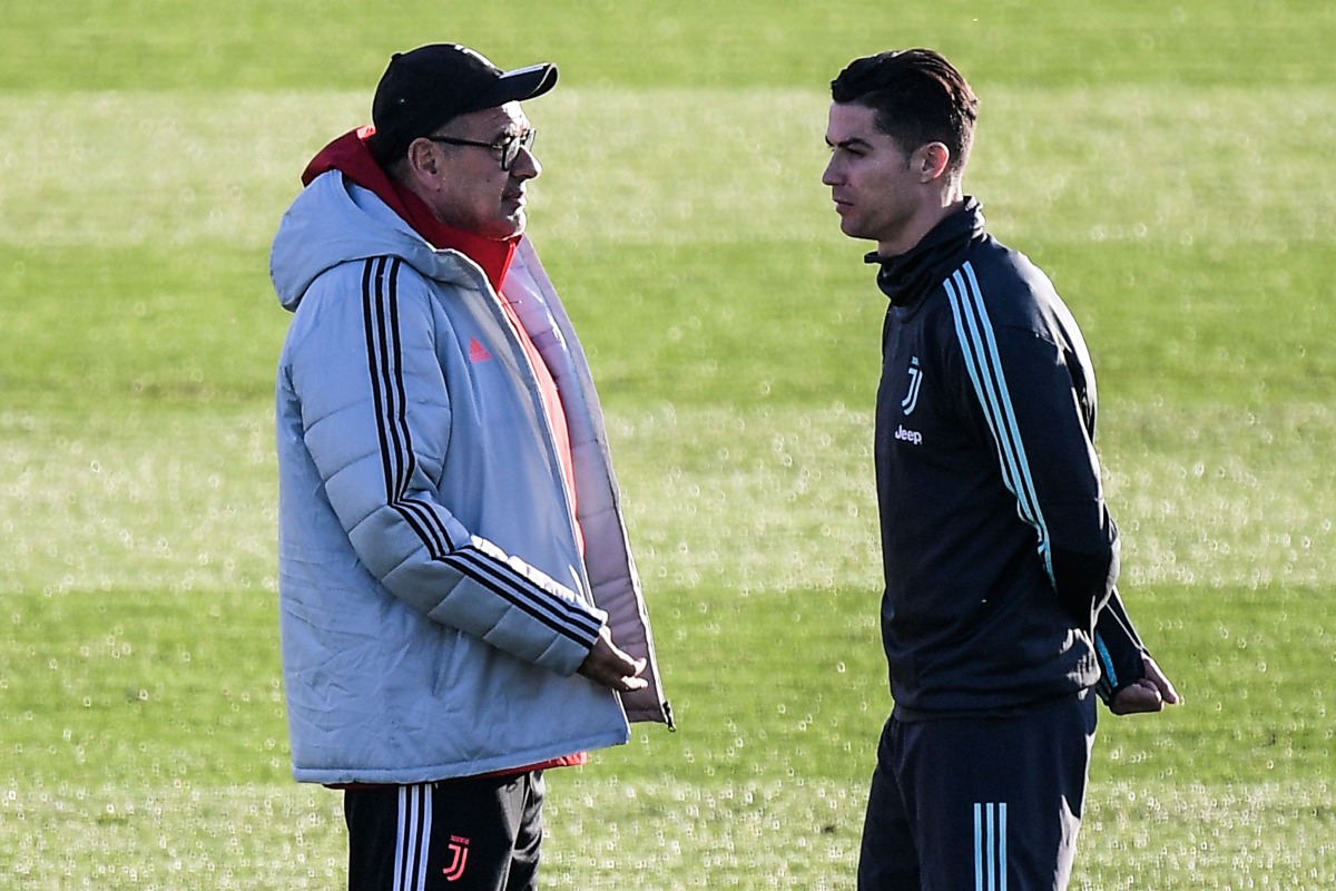 Juventus' Italian coach Maurizio Sarri (L) talks to Juventus' Portuguese forward Cristiano Ronaldo on November 25, 2019 during a training session at the Continassa Training Ground in Turin, on the eve of the UEFA Champions League Group D football match Ju