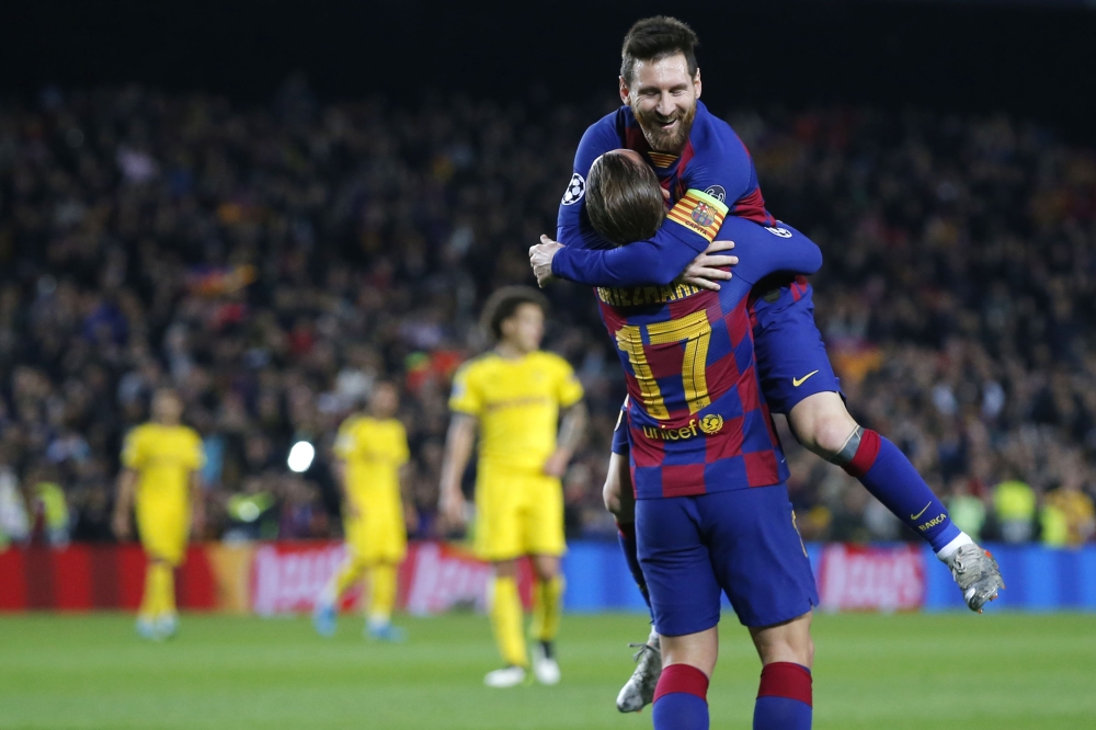 Barcelona's French forward Antoine Griezmann (L) celebrates his goal with Barcelona's Argentine forward Lionel Messi during the UEFA Champions League Group F football match between FC Barcelona and Borussia Dortmund at the Camp Nou stadium in Barcelona, o