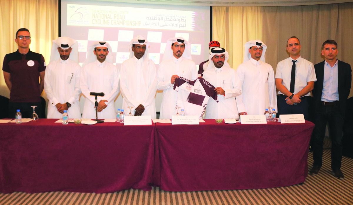 Dr Mohamed Al Kuwari, President of Qatar Cycling and Triathlon Federation and other officials pose for a group picture in Doha yesterday.