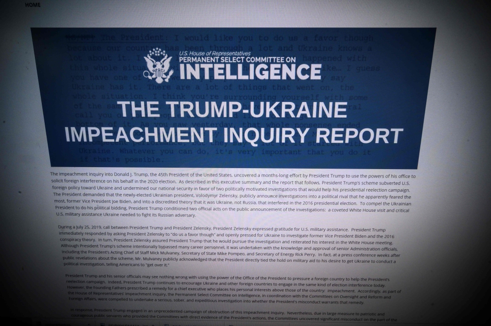 This Computer screen shows a copy of the Permanent Select Committee on Intelligence Report of The Trump-Ukraine Impeachment Inquiry Report on December 3, 2019 in Washington. AFP / Eric Baradat