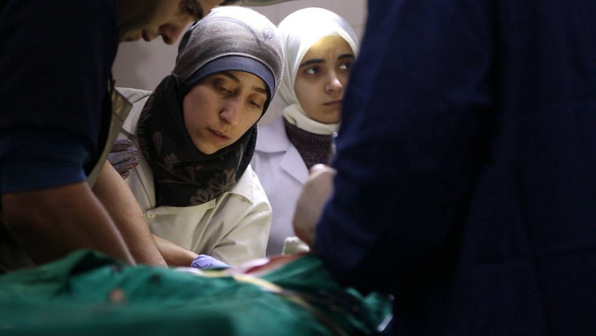 Dr Amani Ballour treats a patient in a scene from the film 