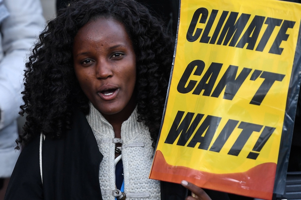 A demonstrator holds a placard during a protest on climate emergency, called by environmental groups including Extinction Rebellion and Fridays For Future, outside the UN Climate Change Conference COP25 at the 'IFEMA - Feria de Madrid' exhibition centre, 