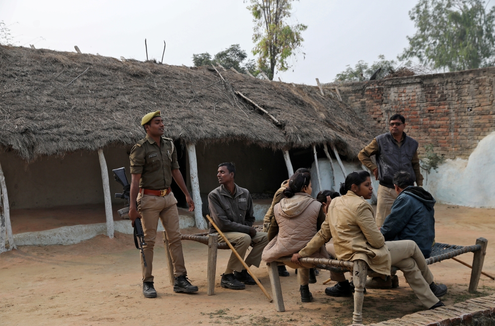Members of police are seen near the house of a 23-year-old rape victim, who died in a New Delhi hospital last week after she was set on fire by a gang of men, which included her alleged rapists, in Unnao, in the northern state of Uttar Pradesh, India Dece