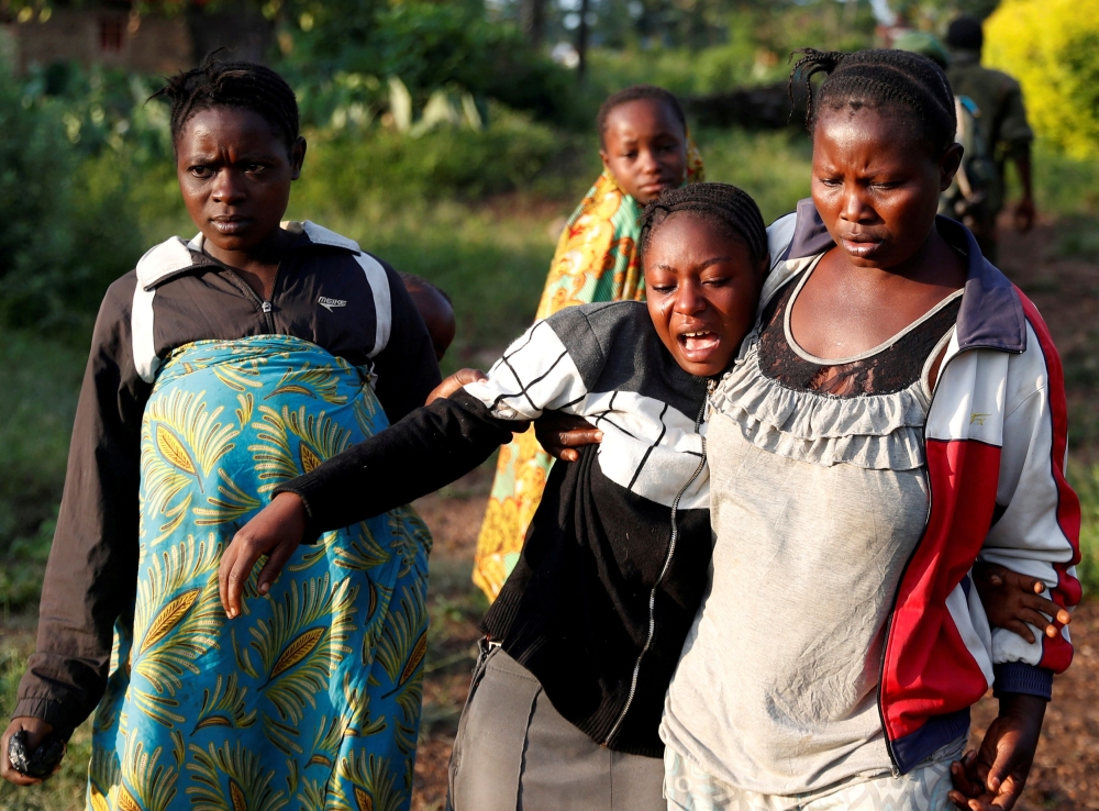 File Photo: A woman reacts after five other women were killed in Paida, near Beni, North Kivu Province of Democratic Republic of Congo, December 7, 2018. Reuters/Goran Tomasevic 