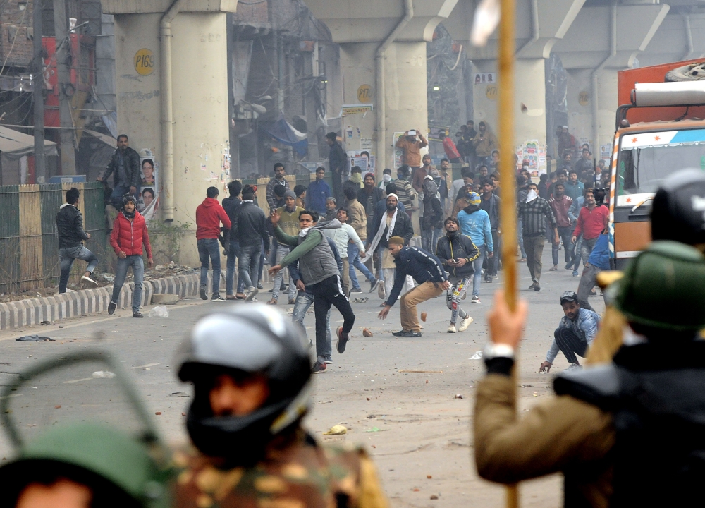 Demonstrators clash with police officers during a protest against a new citizenship law in Seelampur area of Delhi, India on December 17, 2019. (Imtiyaz Khan/Anadolu Agency)
 